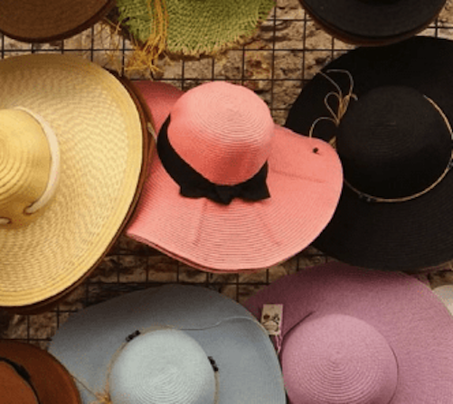 A group of colorful hats stacked on top of each other.