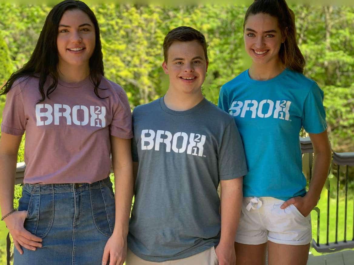 Three young people standing next to each other wearing t - shirts with the word bro.