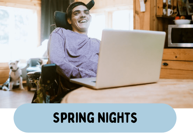 A man in a wheelchair smiling at a laptop, enjoying spring nights while exploring Clubhouse Membership.