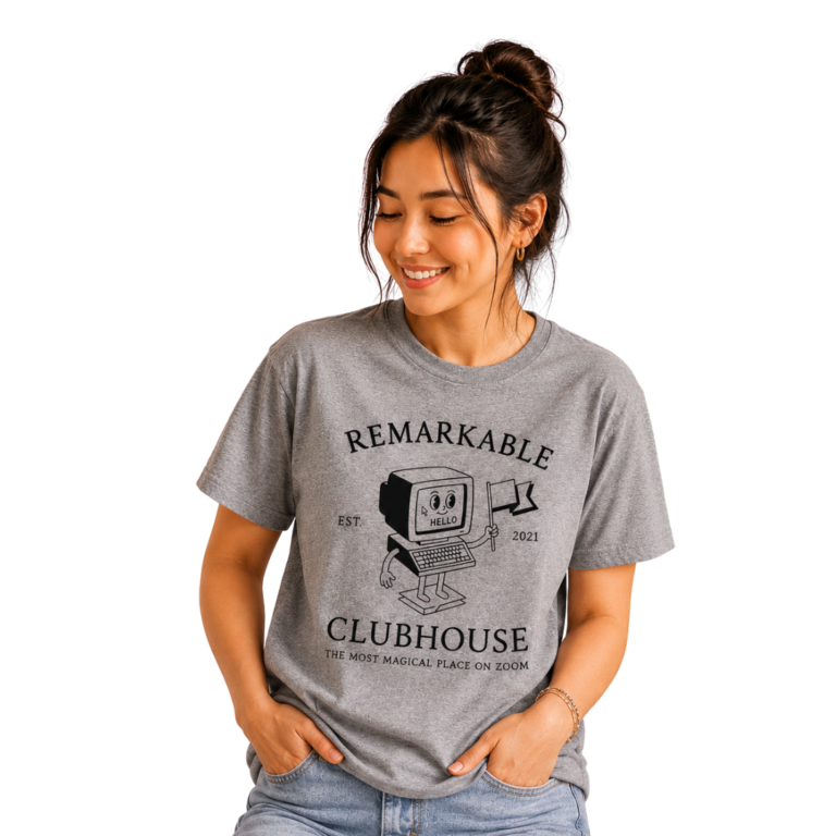 A woman wears the *NEW* Remarkable Clubhouse “Retro” T-Shirt in gray, featuring a cartoon computer and the text “Remarkable Clubhouse” and “The most magical place on Zoom.”.